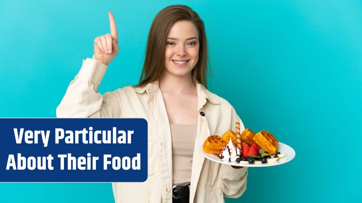 Teenager girl holding waffles over isolated blue background pointing up a great idea.