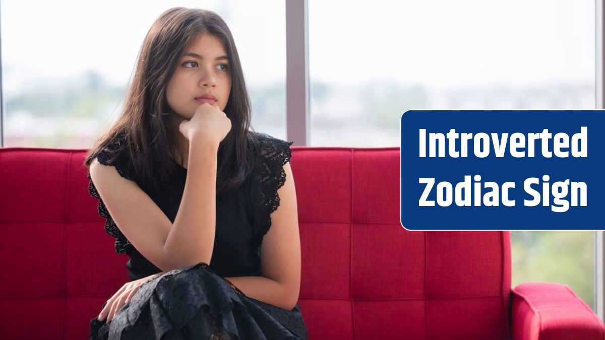 Portrait shot of junior young Thai-Turkish teenager wearing trendy dress sitting on the red couch and posing hand to chin gesture in the studio.